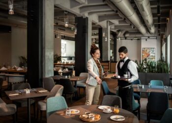 Close up of a restaurant manager talking to the waiter