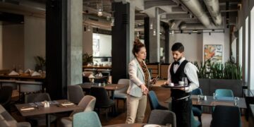 Close up of a restaurant manager talking to the waiter